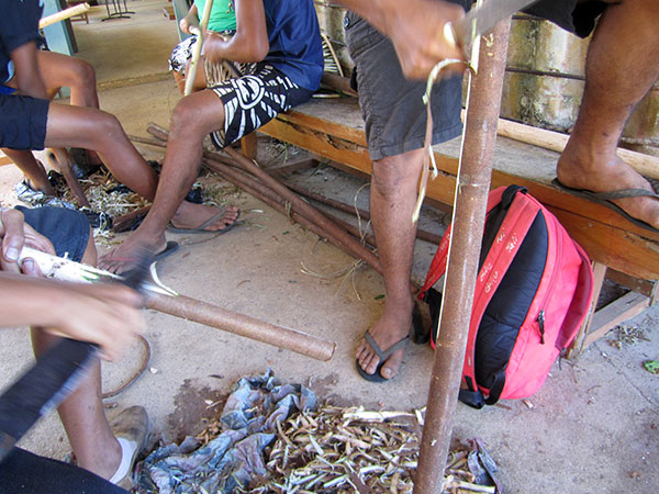 Shaving off bark with a bushknife