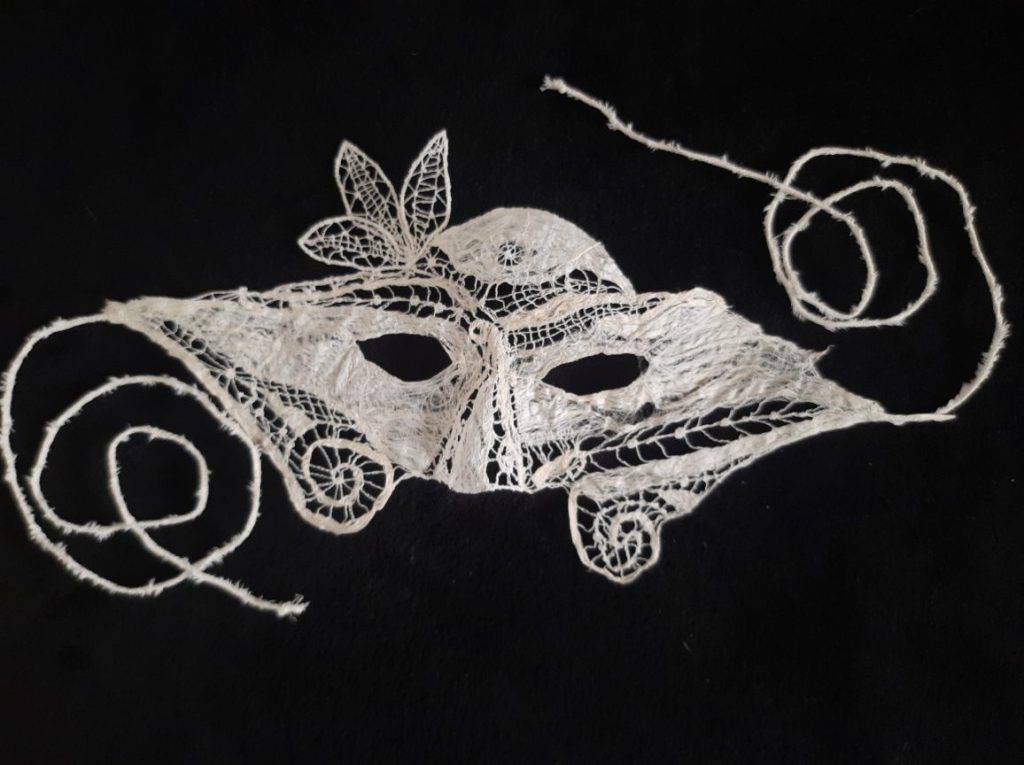 Mask, bark cloth and machine-sewn lace