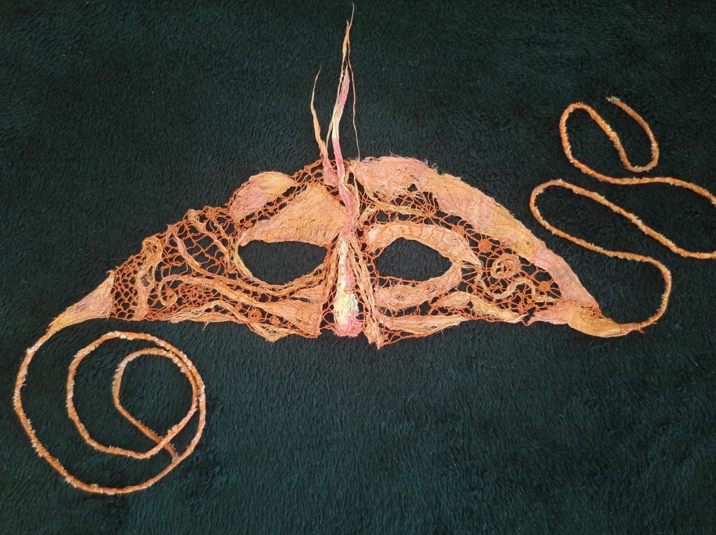 Orange tapa and lace mask